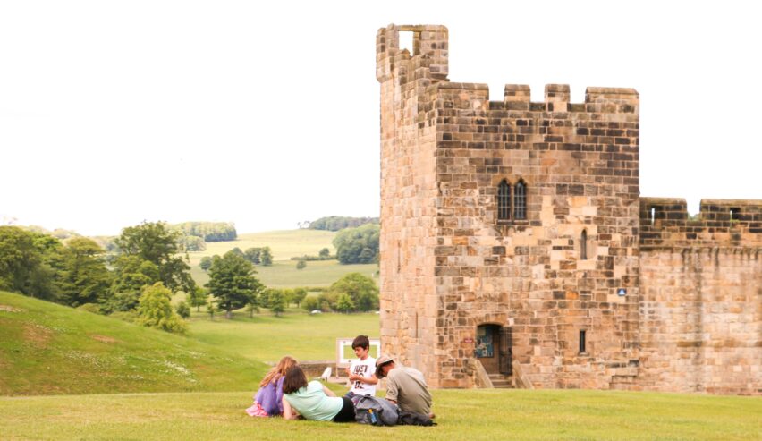 Children sitting by alnwick castle