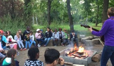 School group campfire fun at Gaveston Hall group hostel near Horsham, West Sussex just 1 hour from London