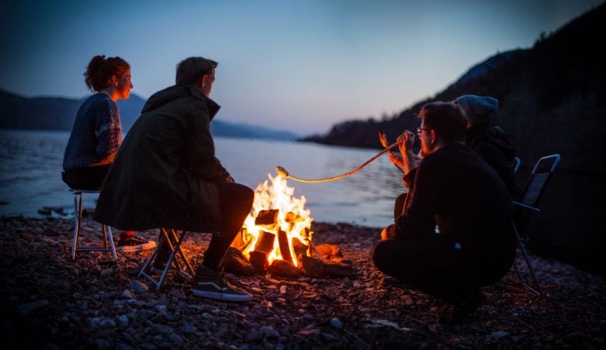 campfire on the banks of lochness by lochside backpackers