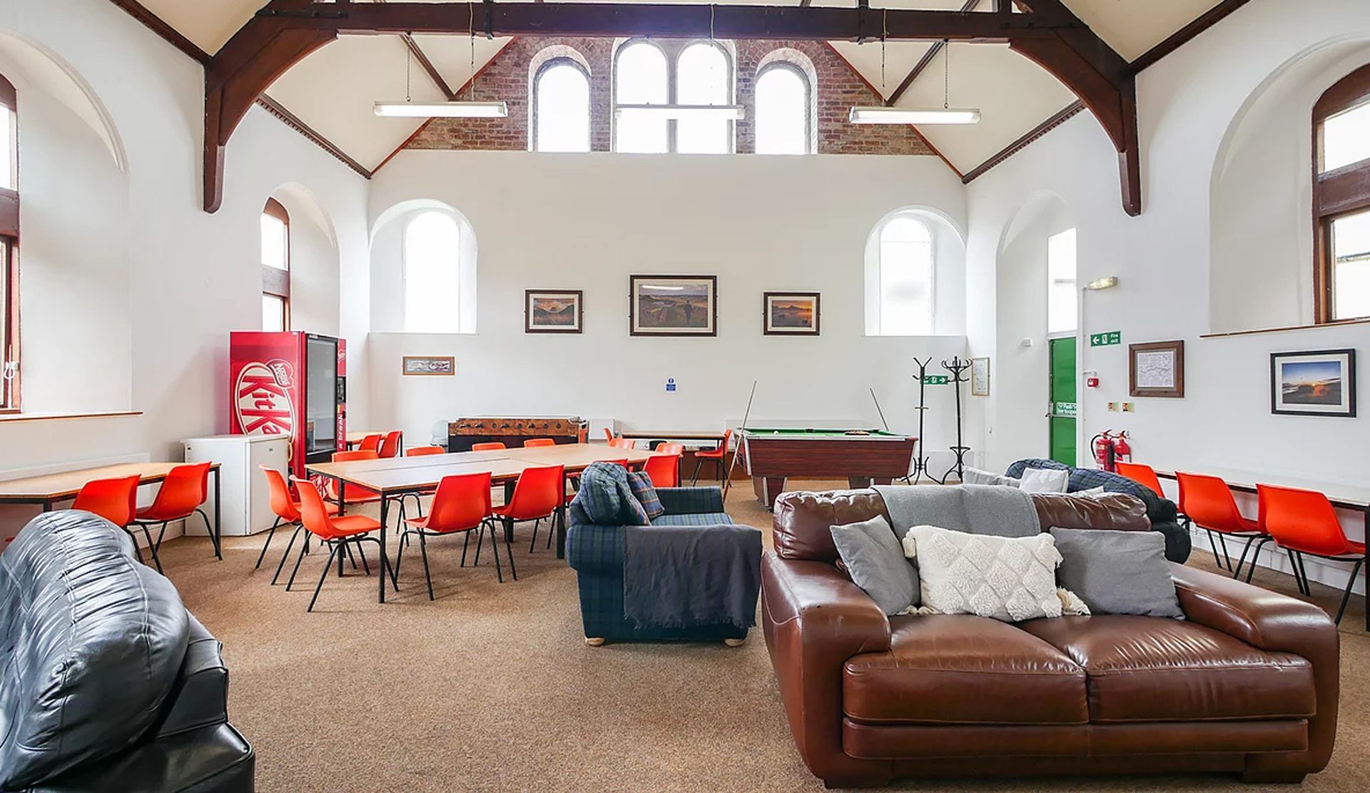 The interior of greenhead hostel with high ceilings and a sofa on hadrian's wall