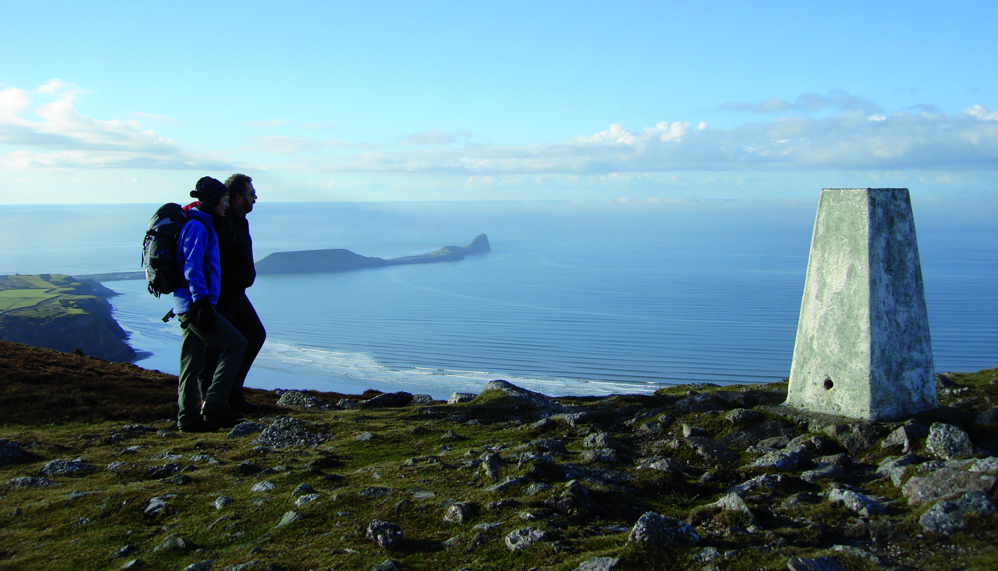Walkers at trip point overlooking Rhossili bayon the Gower Penisular