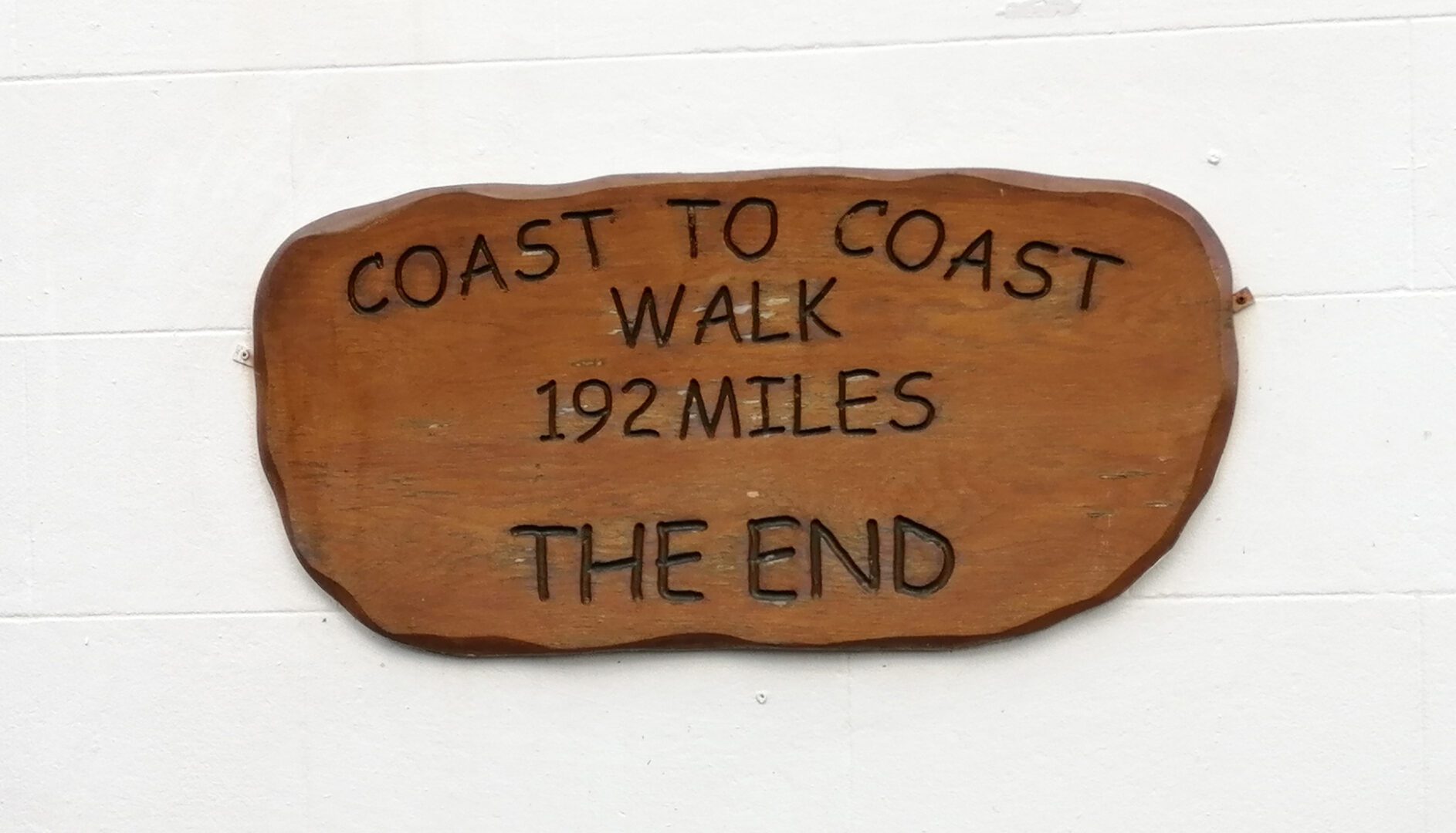 coast to coast walk end plaque at Robin Hoods Bay