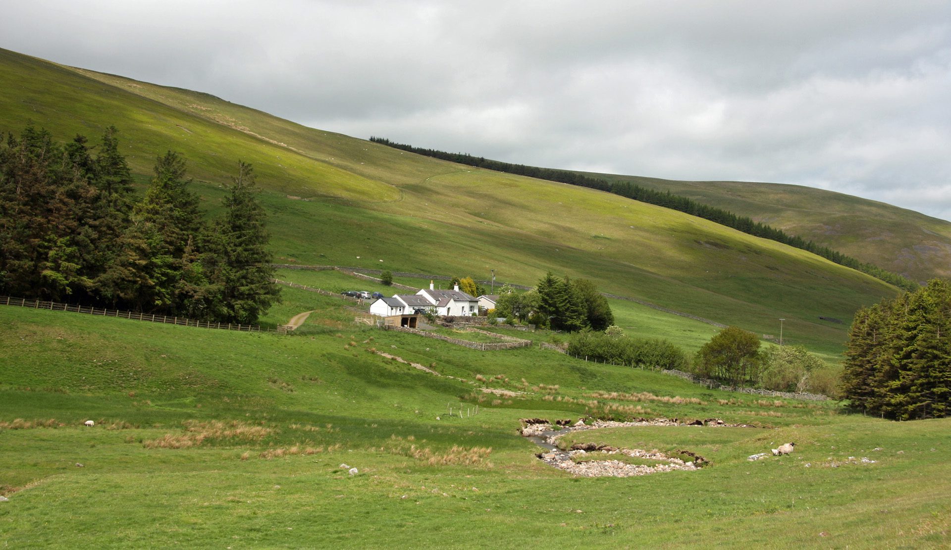 Mounthooly hostel is in the distance on rolling green hills 
