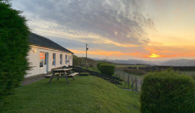 Treks bunkhouse looks beautiful in its rural location with the sun set illumiating the bunkhouse and gardens