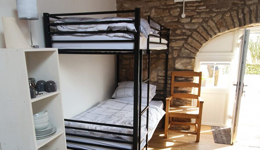 metal bunkbed against stone arched wall