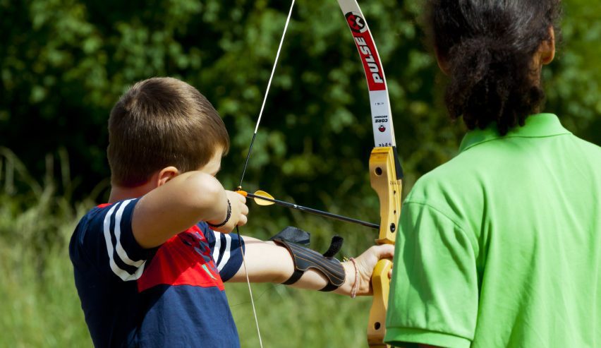 A young boy doing archery