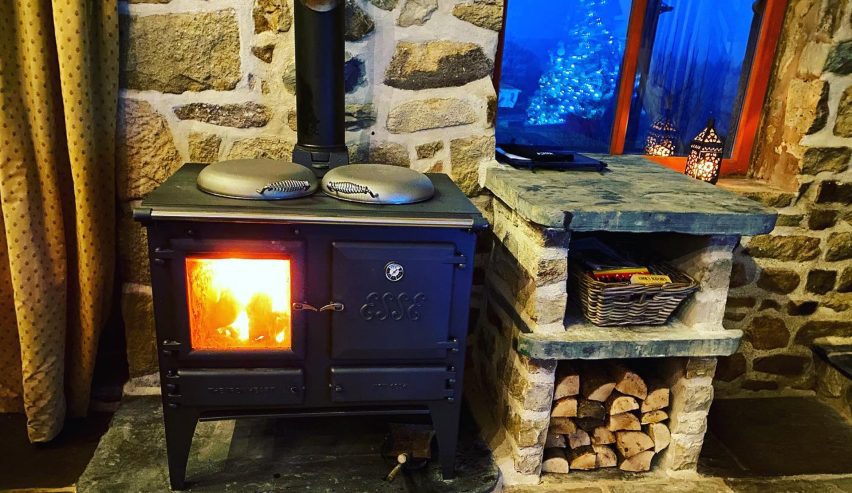 large woodburning cooker, with log store