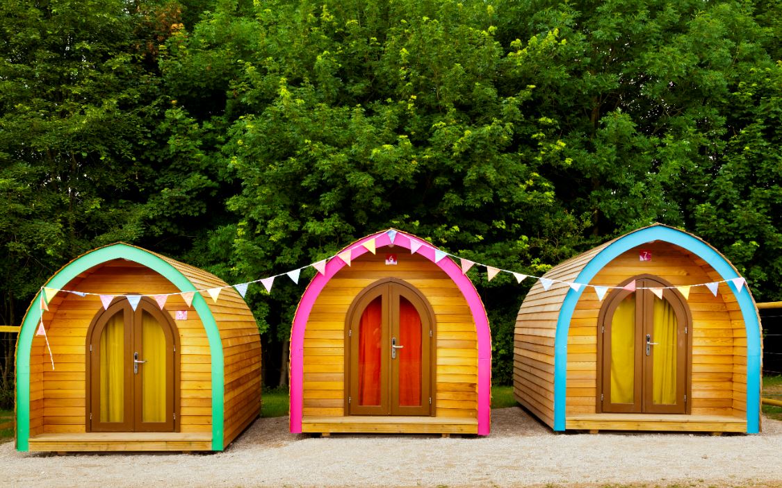 Mount cook glamping pods are perfect for a stag or hen do. The pods are blue, green and pink with bunting.