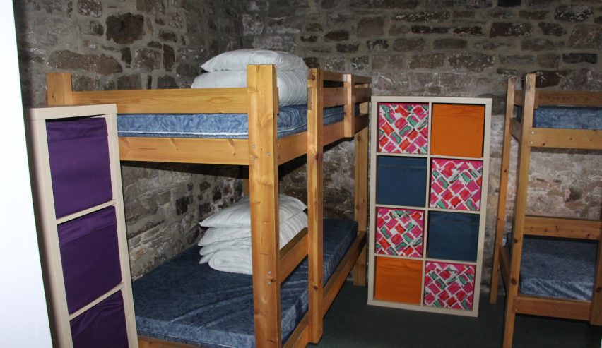 set of bunks with bright storage boxes