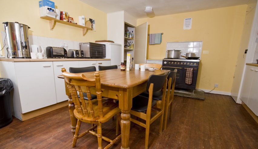 Kitchen with range cooker and pine table and chairs