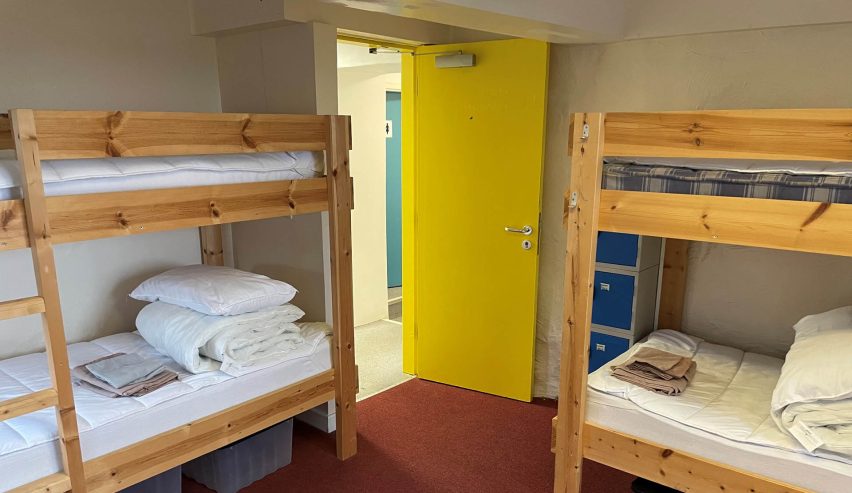 two sets ar bunks and an open yellow door