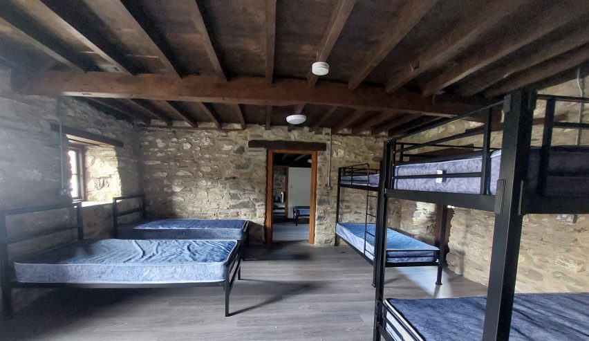 Dormitory with bunks and beds and lovely wooden beamed ceiling