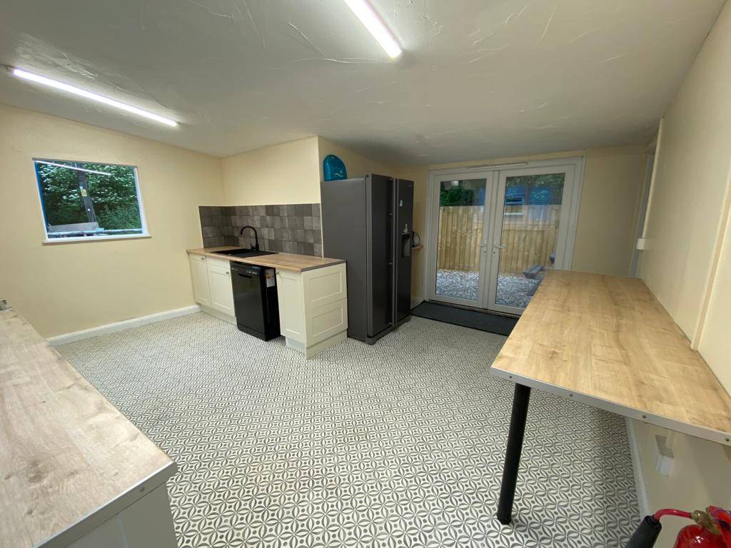 Kitchen with fridge, oven, work surfaces