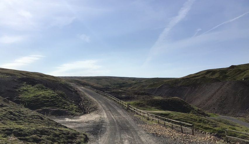 Gravel road leading to the open hillside