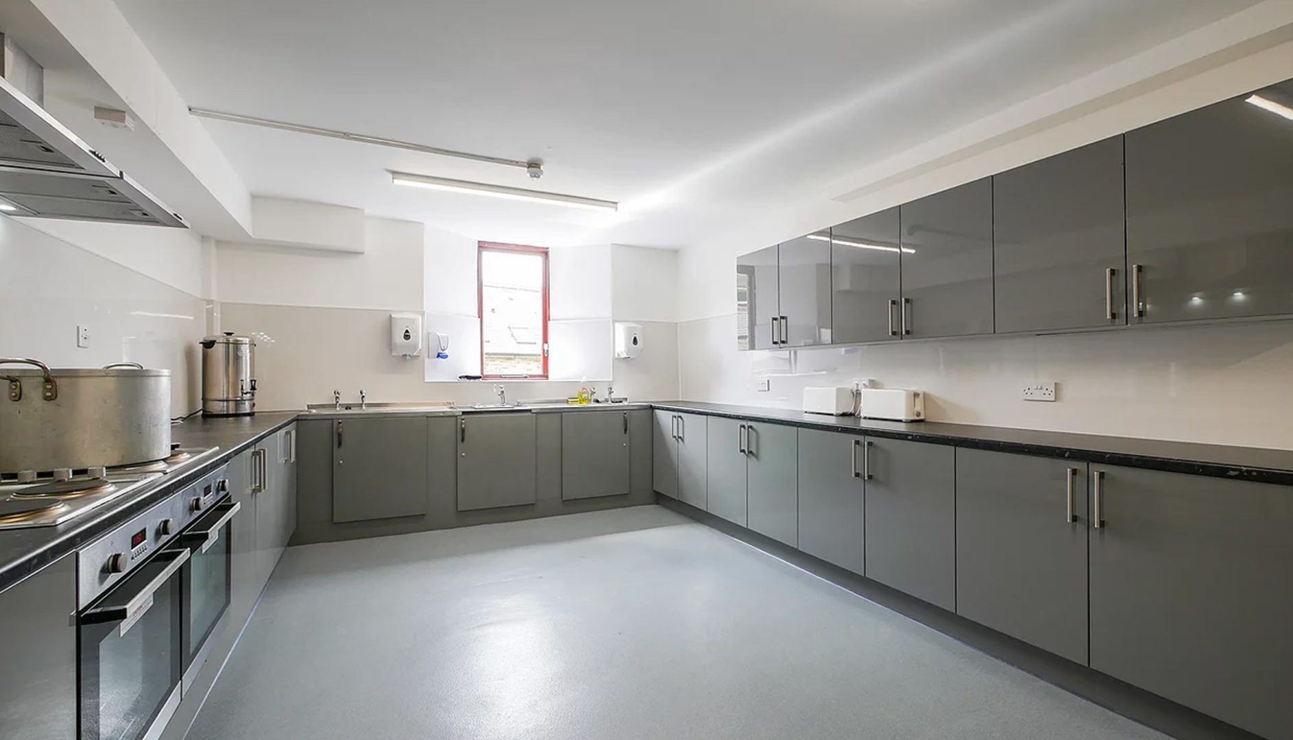 grey, large kitchen with a window at the back