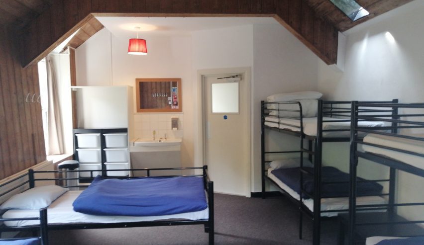 Dorm with metal bunks and single bed