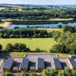 Overhead view of Calvert Devon Lodges showing five lodges and rhe lakes and fields and woods landscape beyond