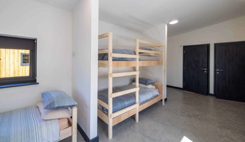 bunkbeds and a single bed in a dorm at Calvert Devon Lodges