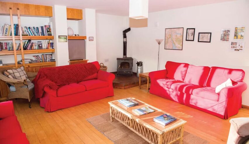 comfy lounge with log burner at Ben Lomond Bunkhouse