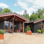 outside view of the front of Shore Lodge Arran National Trust for Scotland Bunkhouse showing lots of window area and flat entrance
